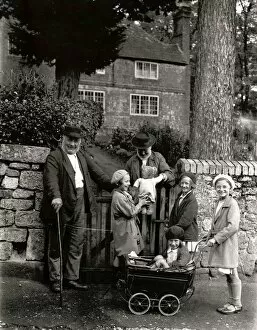 Images Dated 6th June 2012: Two elderly locals chatting to a group of children over the garden gate