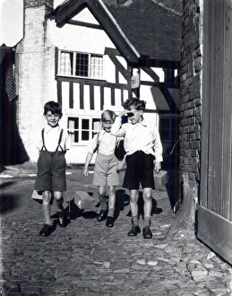 Three evacuees with gasmask boxes, September 1939