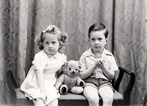 Cute Prints: Girl and boy posing with a teddy bear