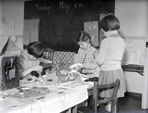 Chichester Photographic Collection: Three girls in a classroom at Lancastrian Infants School, Chichester, May 1956
