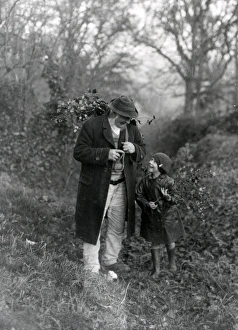 Lane Prints: Grandfather and child gathering holly, December 1932