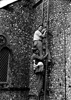 Hoisting the cock on Graffham Church Hoisting the cock on Graffham Church
