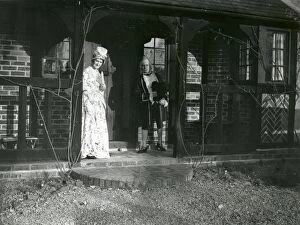 Images Dated 22nd August 2014: Lady and Gentleman in costume standing on a balcony, February 1938