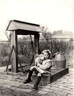 Lamb and girl at Hoes Farm, Sussex