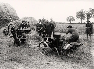 Land Army girls demonstrating thatch making machine, May 1942 Land Army girls demonstrating thatch making machine, May 1942