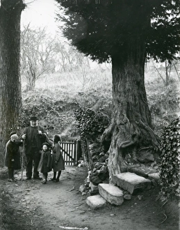 Old man and children walking in the country, December 1935