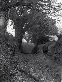 Images Dated 24th July 2013: Old man walking in country lane at Dean, Sussex, January 1935