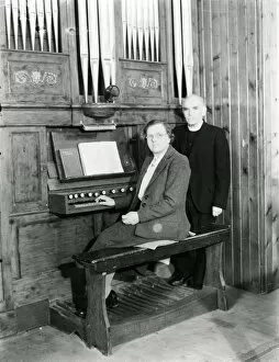 Images Dated 30th May 2008: Organist and vicar seated at the organ