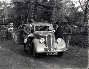 Three people getting into an old car, possibly a Standard, November 1936 Three people getting into an old car, possibly a Standard, November 1936