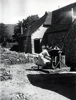 Two people using a well on a farm at Upperton, Sussex, August 1936 Two people using a well on a farm at Upperton, Sussex, August 1936