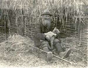 Shepherd fitting lamb-skin to motherless lamb in Angmering, April 1934 Shepherd fitting lamb-skin to motherless lamb in Angmering, April 1934