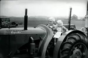 Rural Collection: Two small children on a tractor, 1949