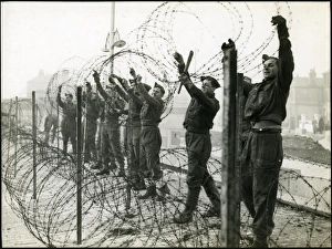 Uniform Prints: Soldiers putting up barbed wire entanglements on the seafront, Bognor Regis 1940