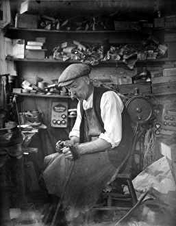 The village shoemaker at work in his shop, 1920s