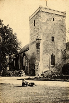 Well-dressed man reclining on the lawn in front of the church at Beeding, 23 March 1893