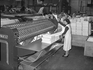 Machinery Prints: Woman making bed linen in a factory, 1960s