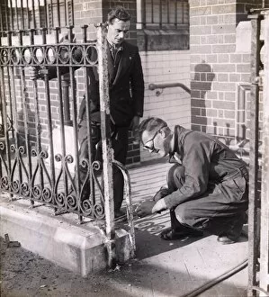 Images Dated 15th February 2013: Workmen removing iron railings [1939-1945]