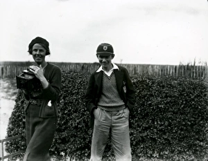 Young boy in cap and young lady with camera in field, September 1938 Young boy in cap and young lady with camera in field, September 1938