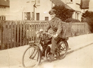 Military Prints: Young man in military uniform on motorbike, c1920s